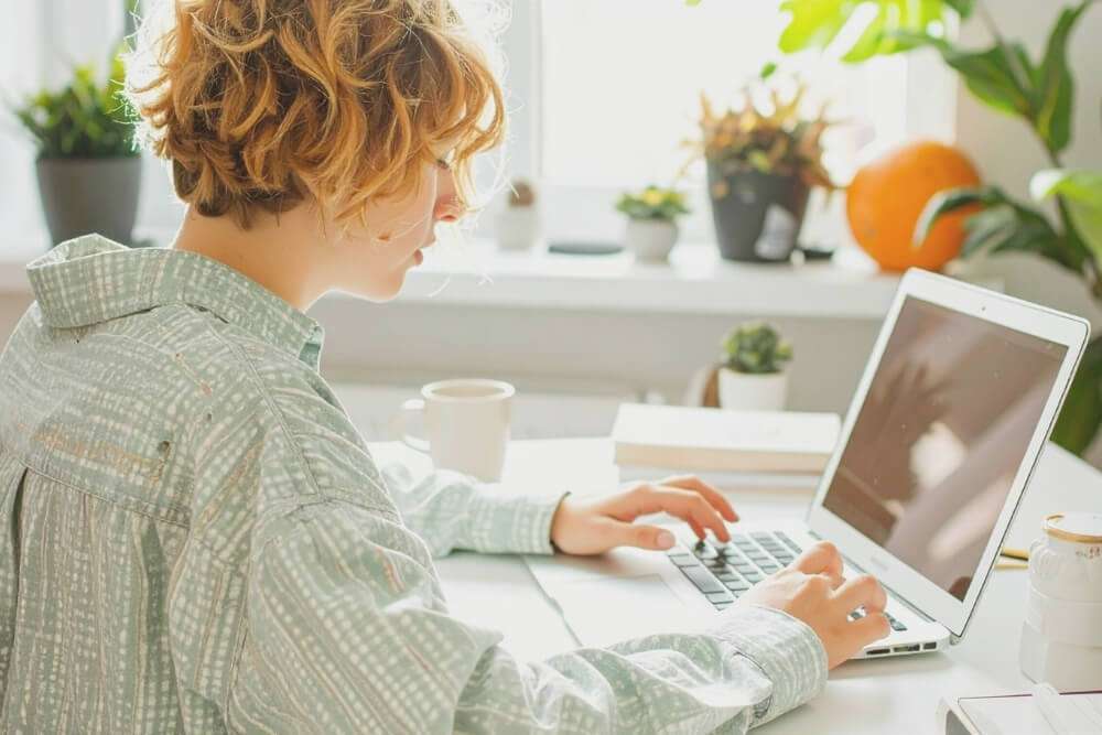 Titelbild: Wie funktioniert digitale Buchhaltung. Frau am Schreibtisch vor dem Laptop.